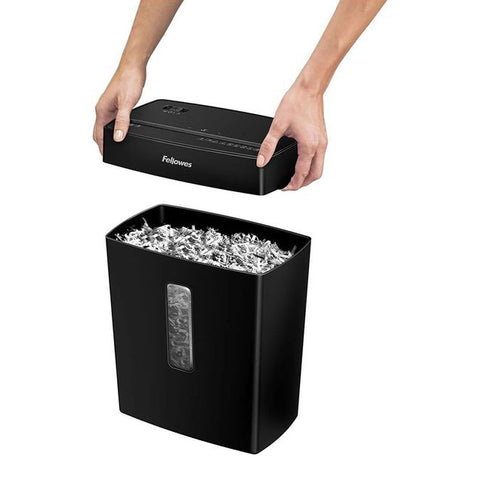 Top‑slot paper being fed into the Fellowes P‑42C shredder, illustrating the start of shredding action.