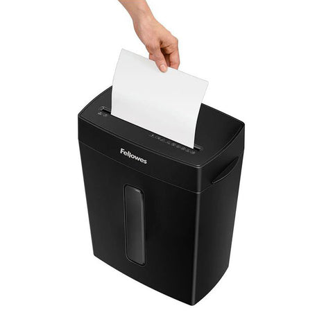 Top‑slot paper being fed into the Fellowes P‑42C shredder, illustrating the start of shredding action.
